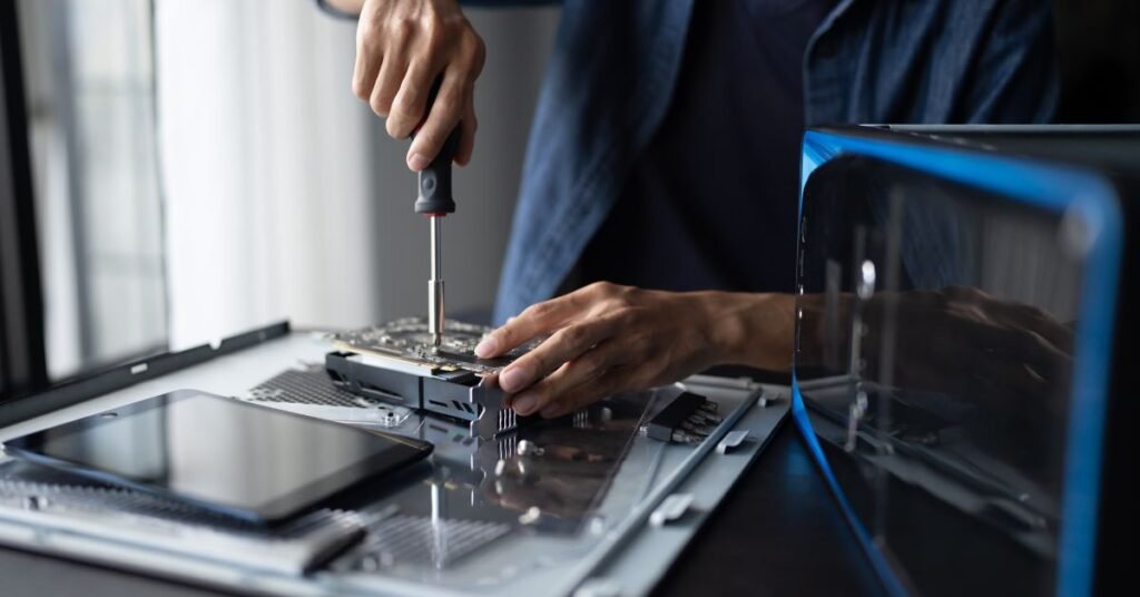 Person repairing computer hardware using screwdriver for tech learning and skills development